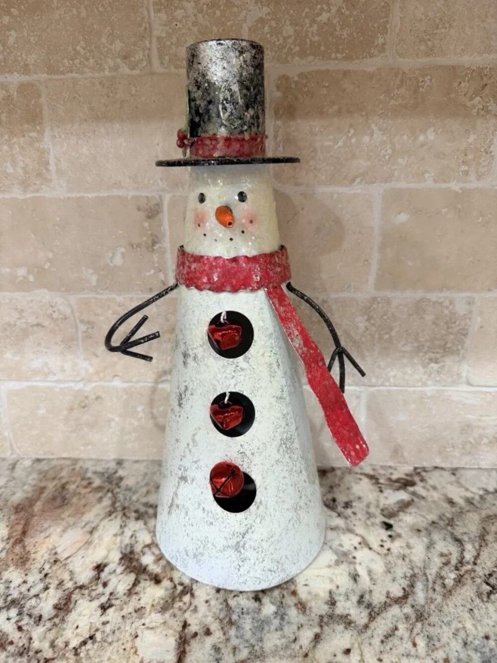 Folk-art metal cone snowman top hat, scarf, wire arms, red jingle bell buttons.